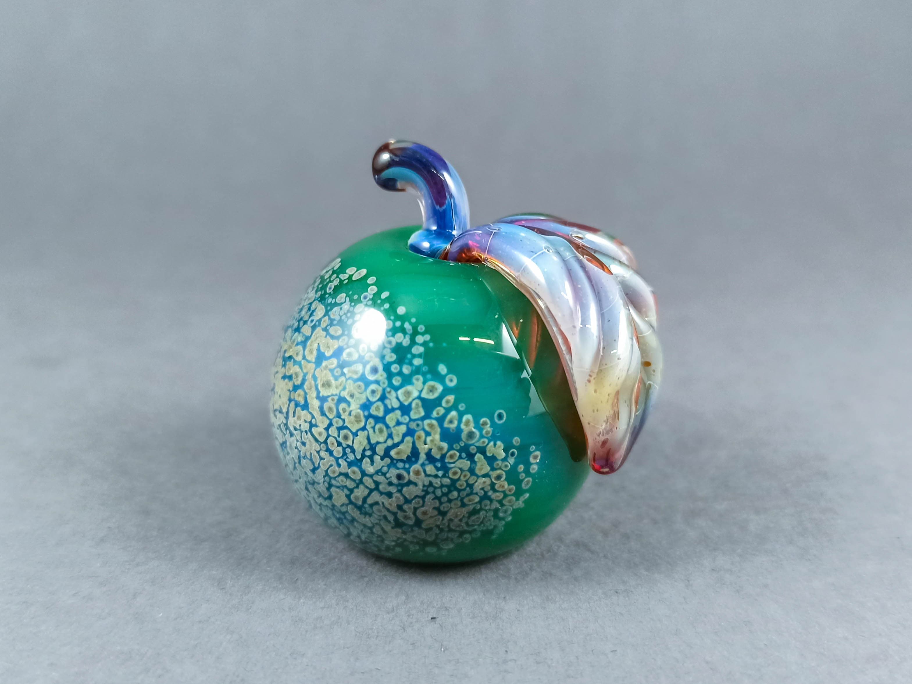 Solid Glass Apple Marble with a Leaf, v265 — handmade borosilicate glass by NoccoNocco, detail view 4 of 4, made in Greece
