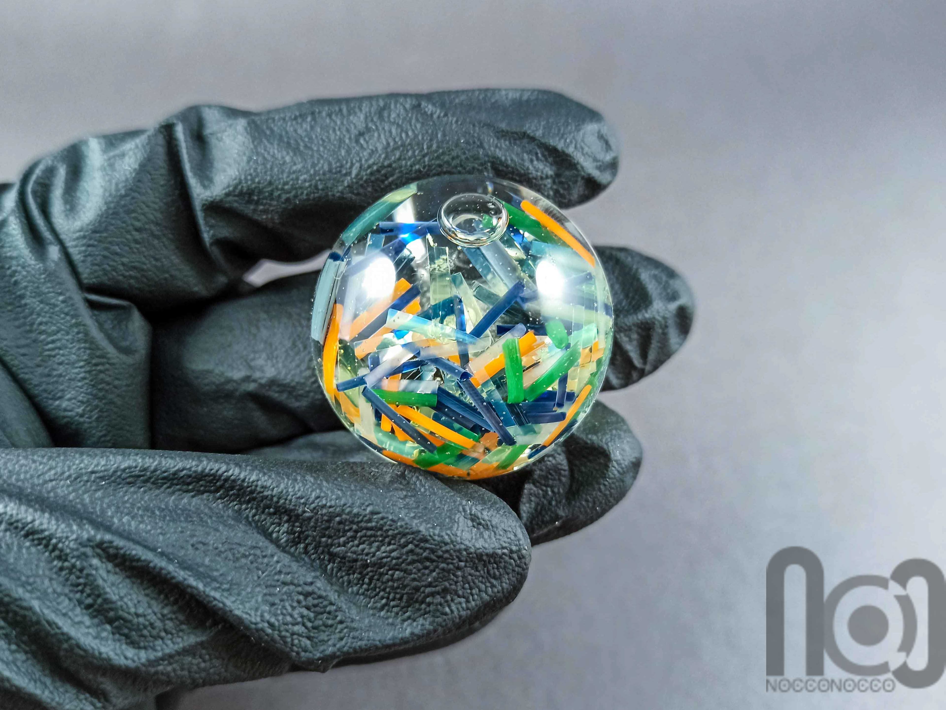 Hollow Glass Marble Filled with Colorful Glass Pieces Floating In Liquid, v292 — handmade borosilicate glass by NoccoNocco, detail view 3 of 3, made in Greece