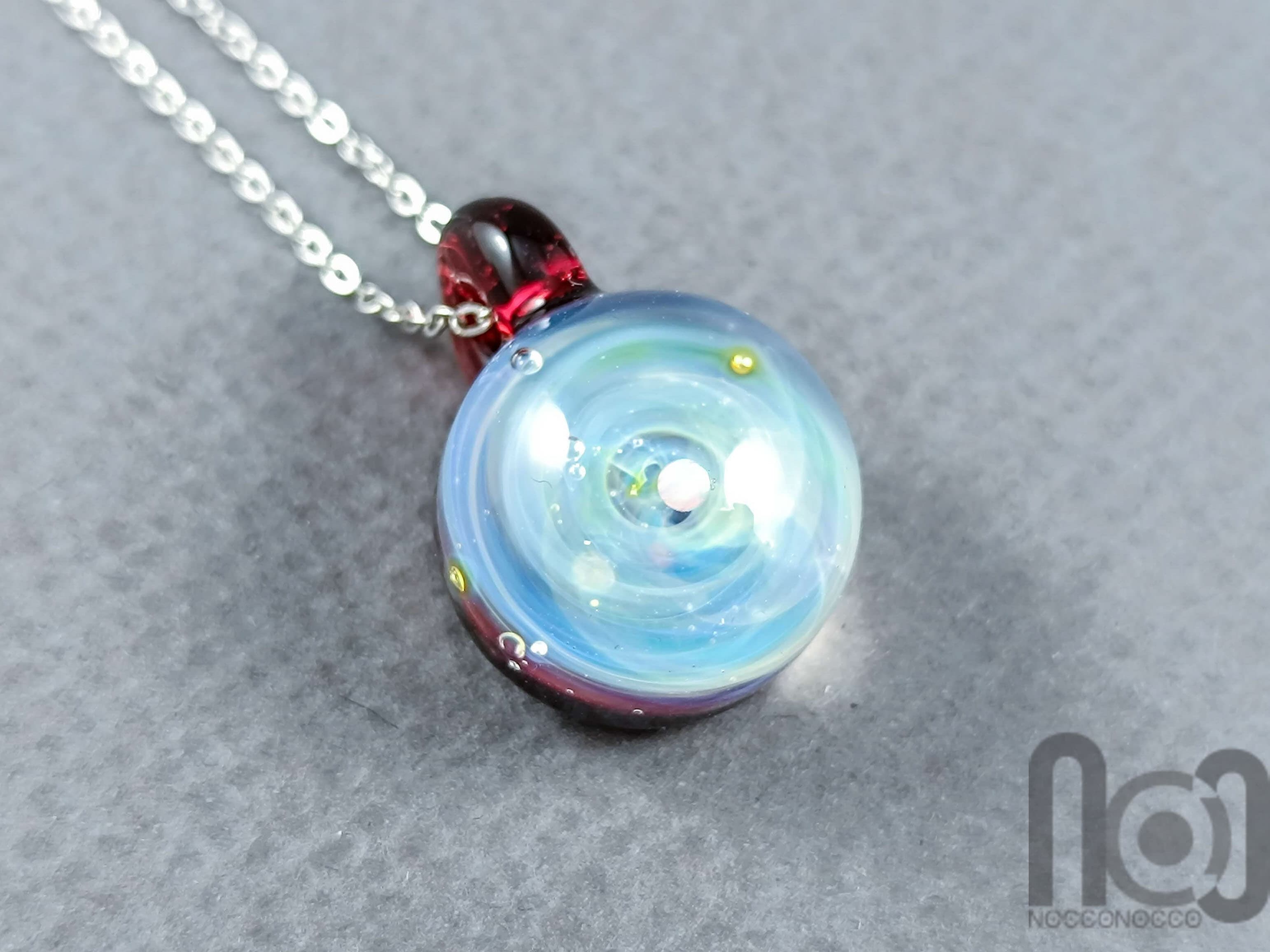 Tiny Galaxy Pendant with an Opal Planet, v302 — handmade borosilicate glass by NoccoNocco, main view, made in Greece