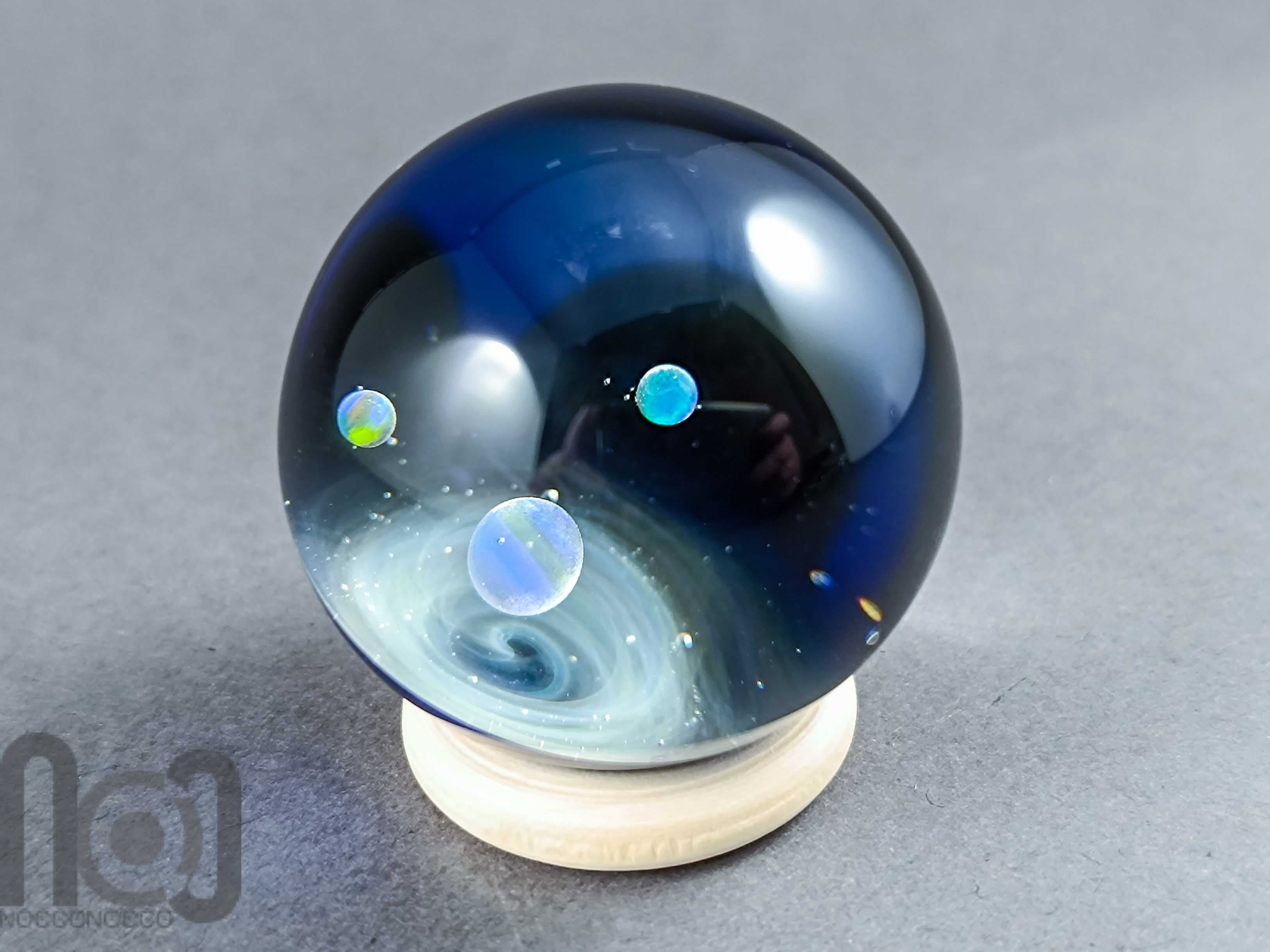 Galaxy Marble with 3 Floating Opal Planets and Decorated Backside, v573 — handmade borosilicate glass by NoccoNocco, detail view 3 of 6, made in Greece