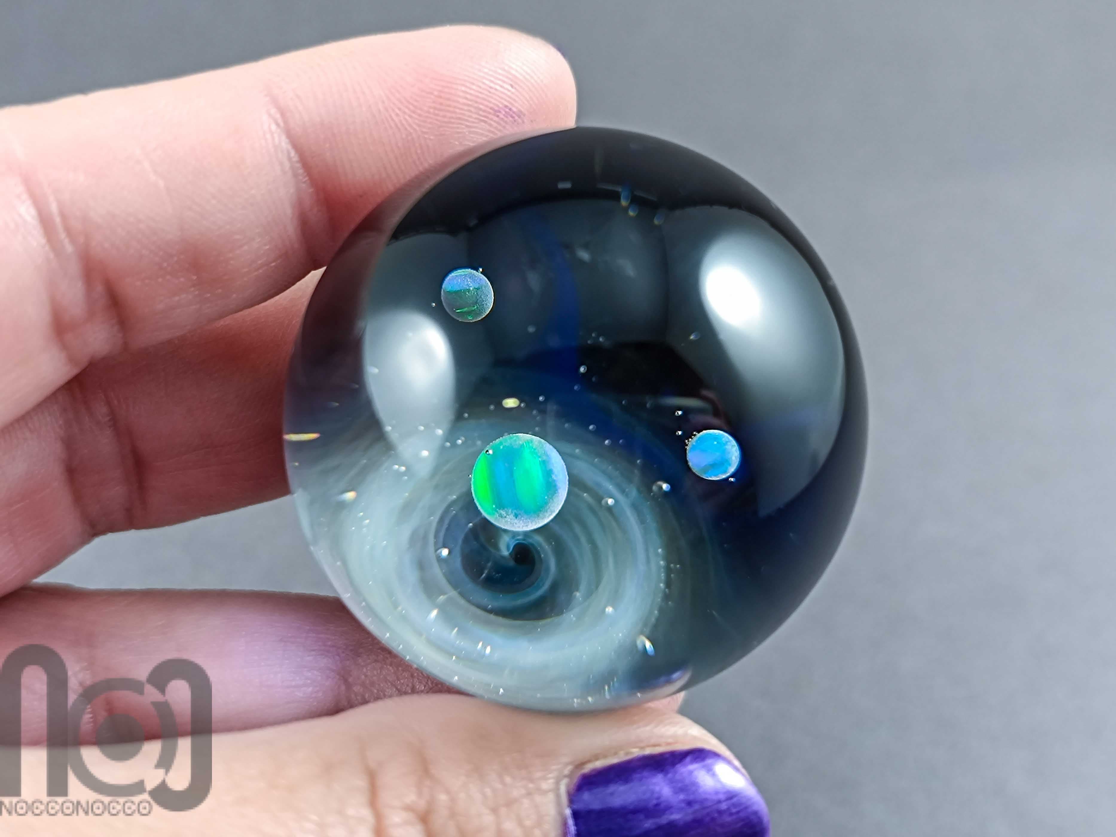 Galaxy Marble with 3 Floating Opal Planets and Decorated Backside, v573 — handmade borosilicate glass by NoccoNocco, detail view 5 of 6, made in Greece