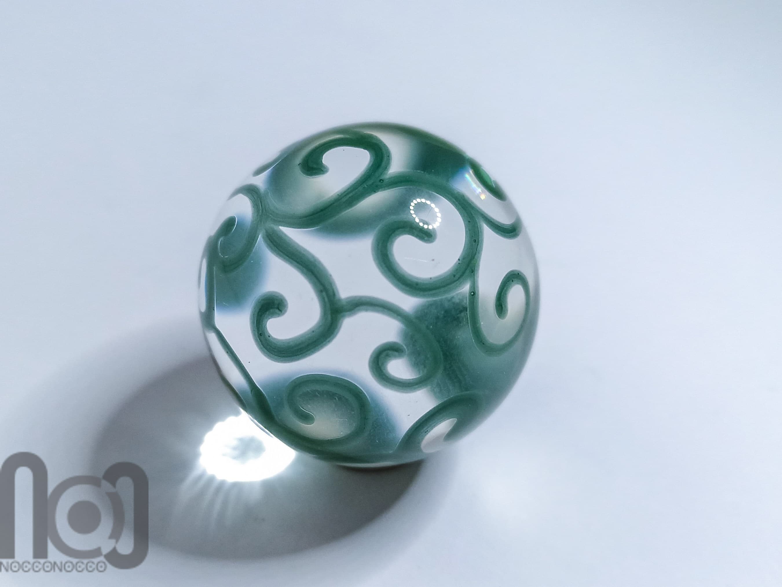 Handmade Clear Glass Marble with Green Scrolls, v127 — handmade borosilicate glass by NoccoNocco, main view, made in Greece