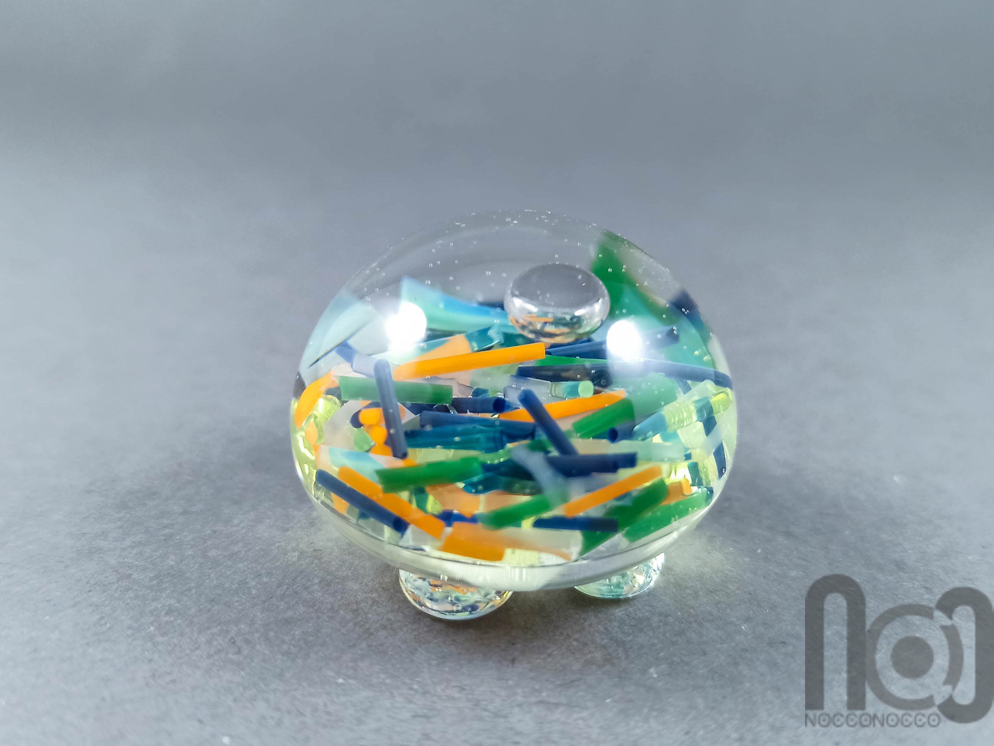 Hollow Glass Marble Filled with Colorful Glass Pieces Floating In Liquid, v292 — handmade borosilicate glass by NoccoNocco, detail view 2 of 3, made in Greece